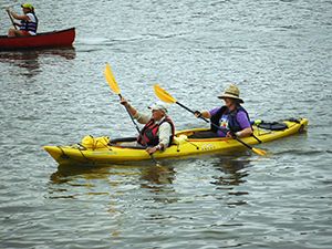 Buffy Curtis and Liseli Haines paddling with the Two Row Wampum Renewal Campaign